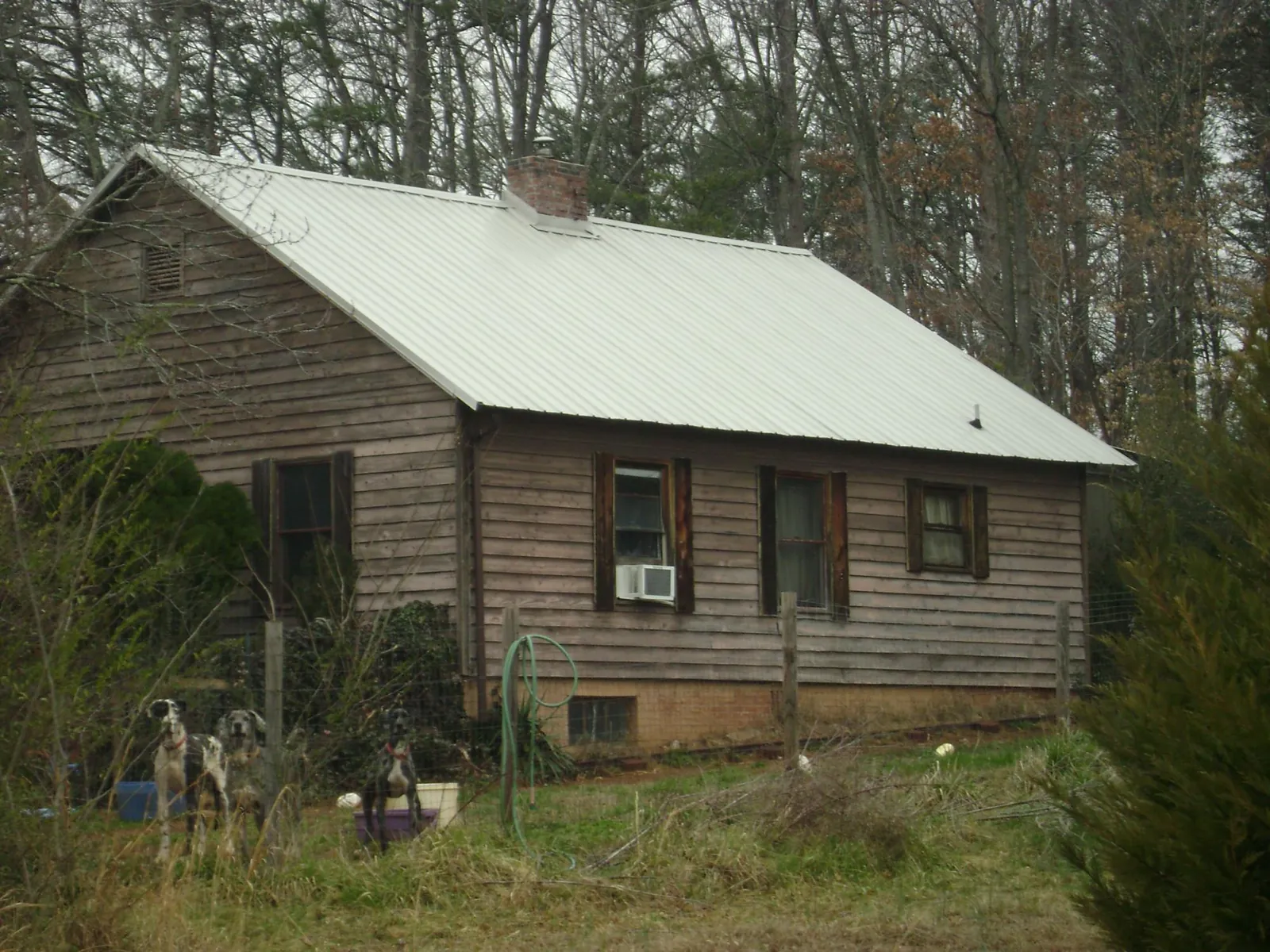 White metal roof on an old wood sided farmhouse, from a Metal Roof Installation job in Red Banks